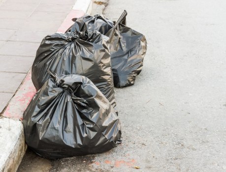 Professional rubbish removal team sorting waste materials in Harlesden